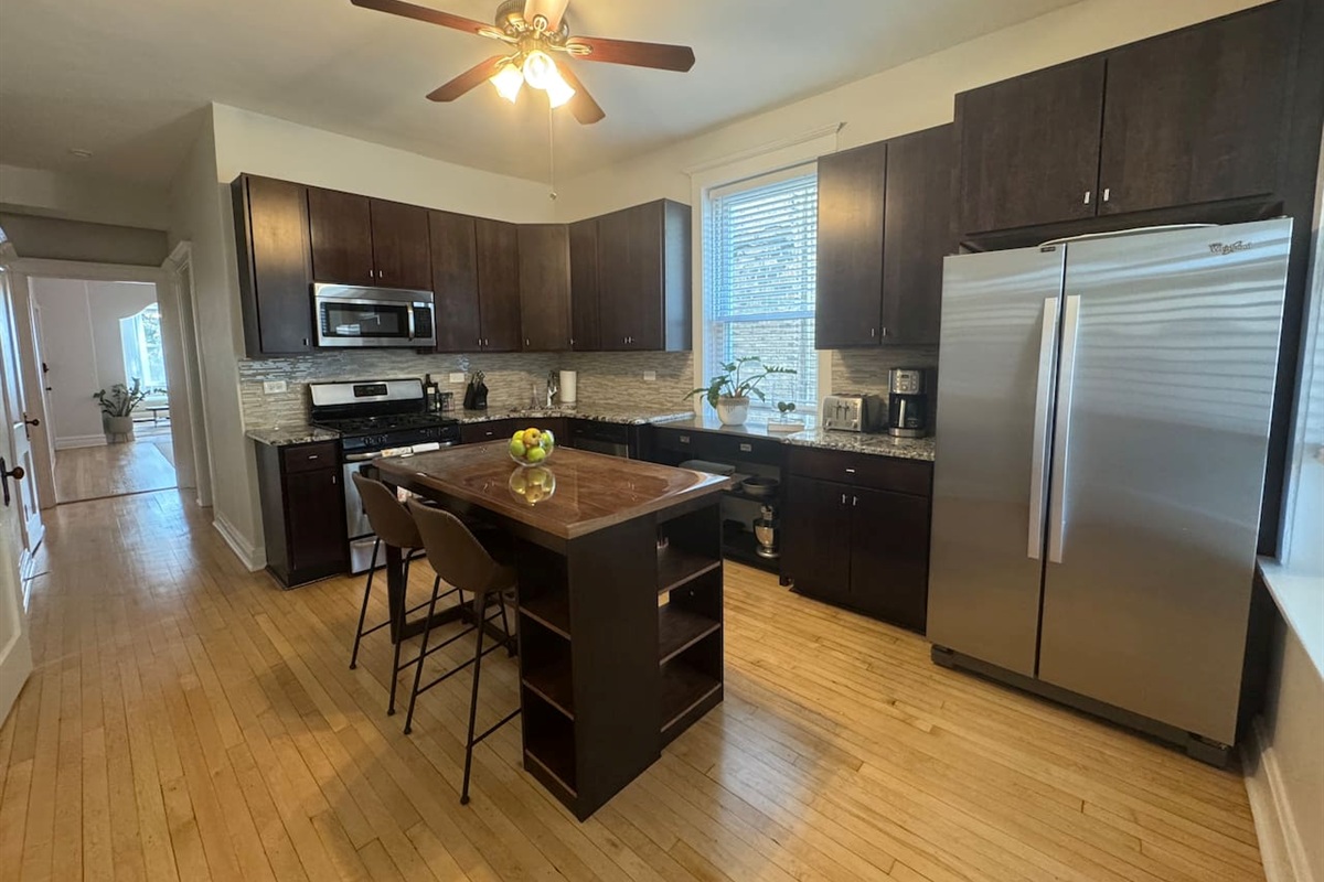 Large modern kitchen with stainless appliances and spacious island.