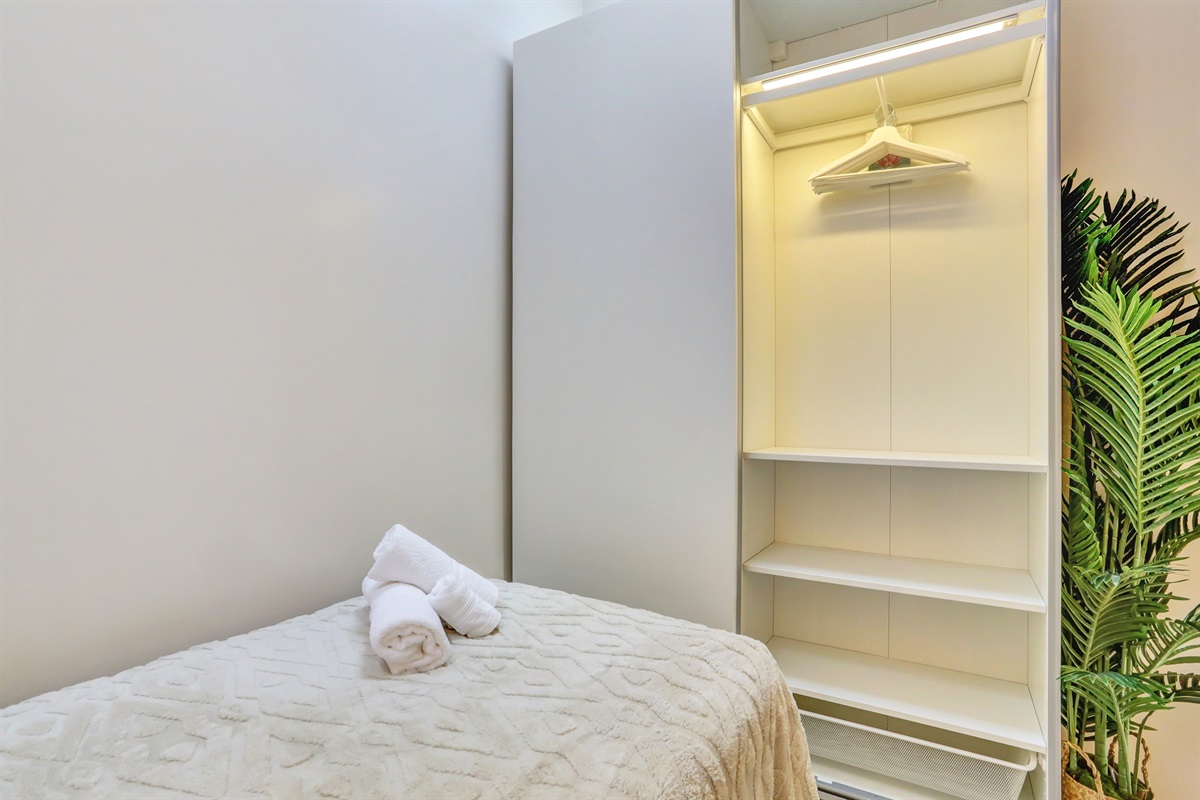 Second bedroom with a spacious wardrobe and storage space, ideal for a comfortable and organised stay.