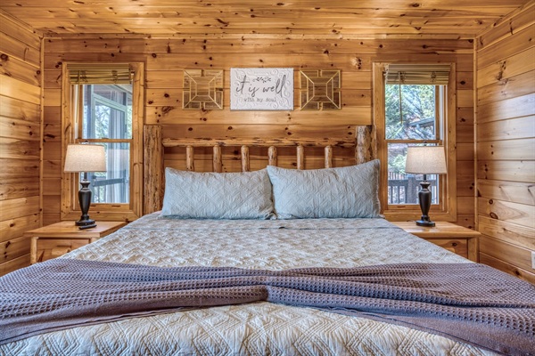 Main-level master bedroom includes a king bed, a private full bathroom, and mountain views! The screened-in patio is right off the master bedroom. 