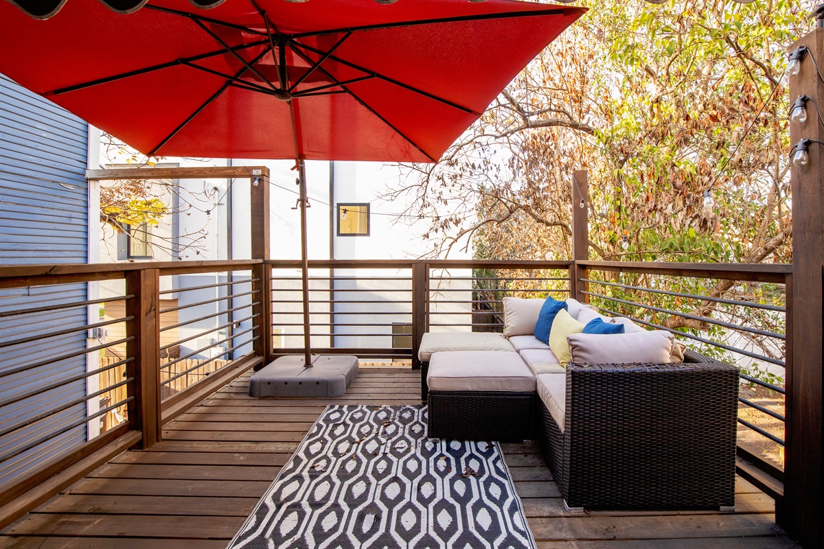 Sip, sit, and unwind – this balcony oasis with comfy chairs and a table is a haven of relaxation and scenic views