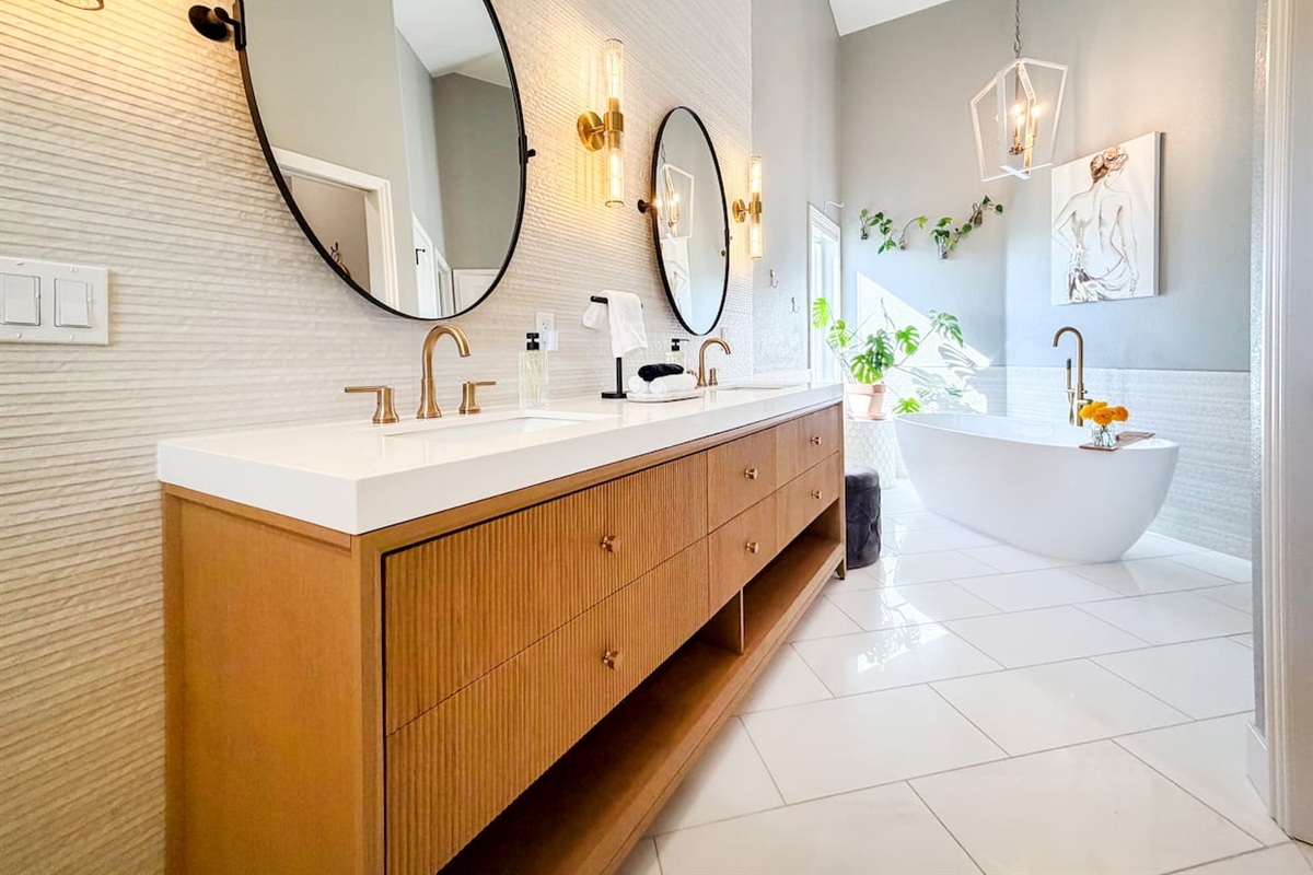 Indulge in a spa-like retreat in the luxurious master bathroom, featuring a custom double vanity and a standalone tub designed for ultimate relaxation and privacy.”