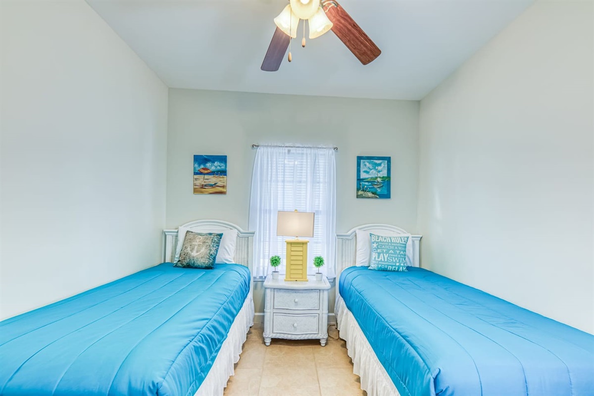 Kid's Retreat: Bright twin beds with beachy decor create a fun, inviting space for young guests!