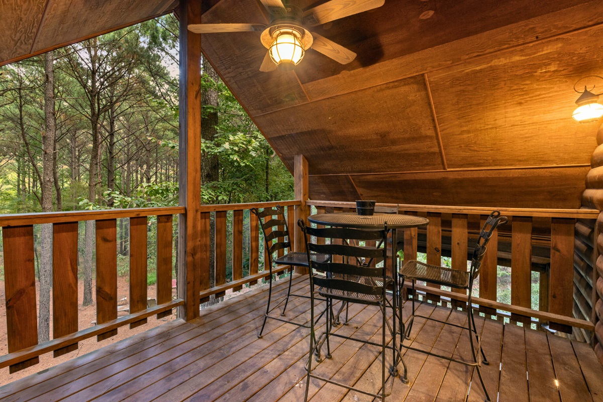 Upper balcony with forest views and ceiling fan breeze