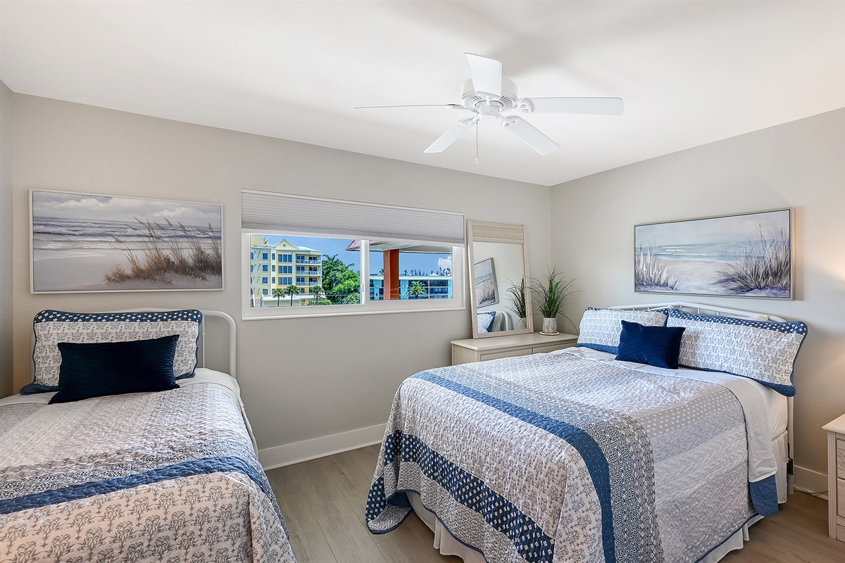Guest bedroom has new queen and twin beds with a view of the inlet