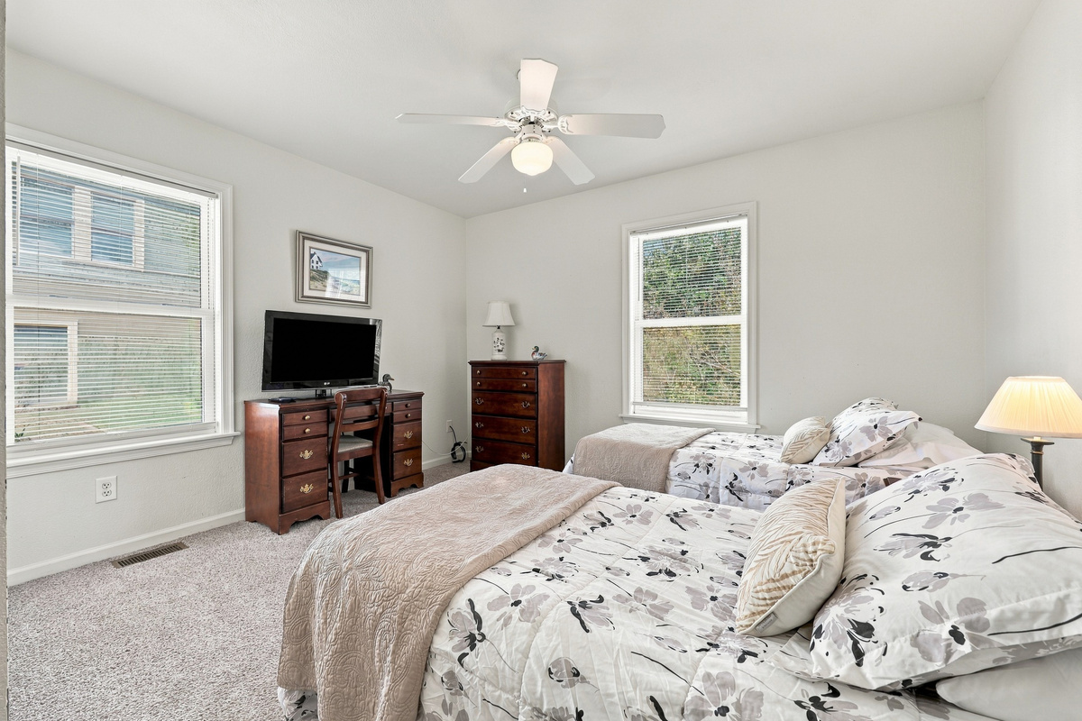 A bright two-bed room with a TV and desk. Great for kids or friends.