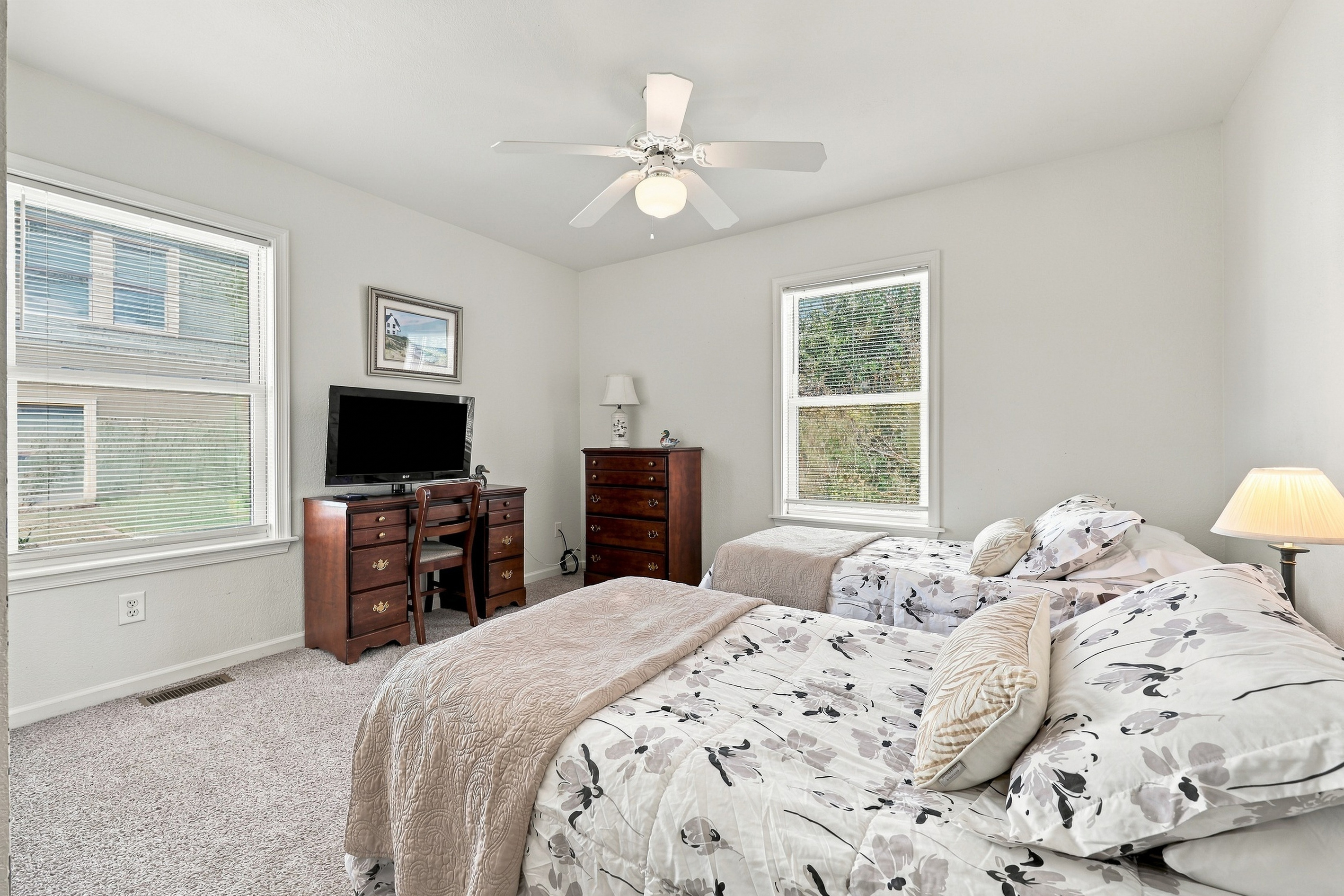 A bright two-bed room with a TV and desk. Great for kids or friends.