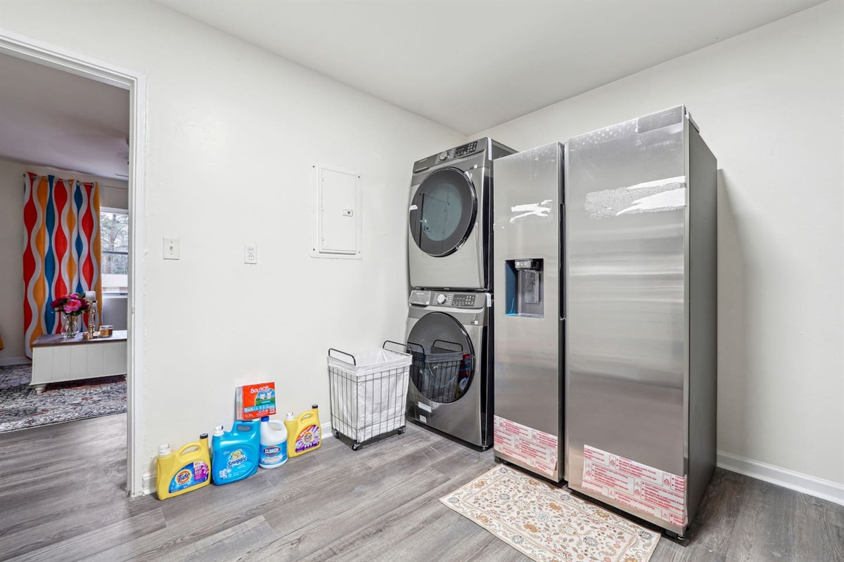 A convenient laundry area near the kitchen equipped with a washer, dryer, and laundry essentials like detergent and softener — perfect for guests who wish to do laundry during their stay.
