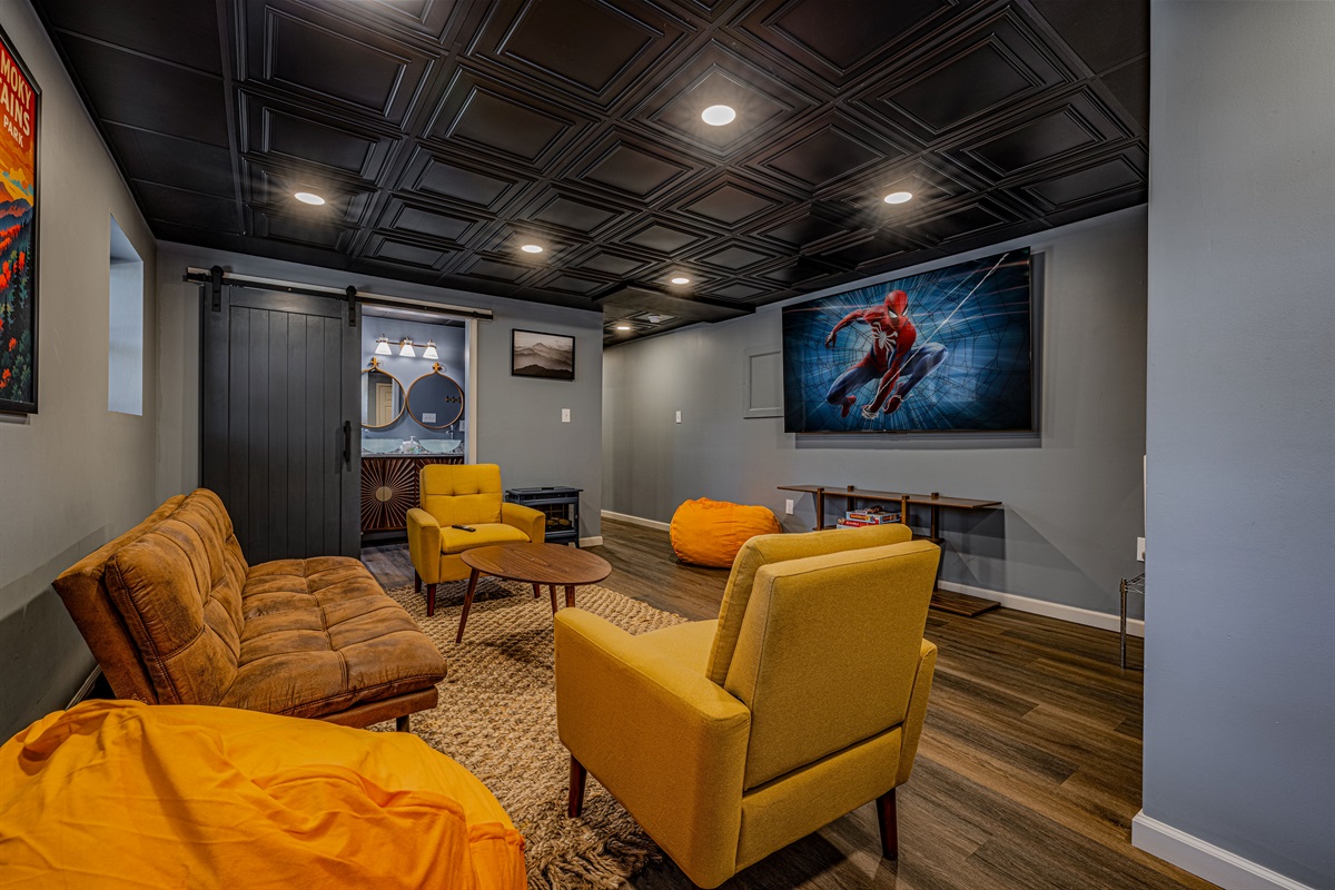 Sink into plush bean bags or the vintage-inspired sofa. This inviting space is designed for long evenings of relaxation and fun after a day in the mountains.