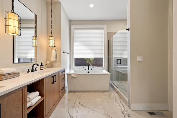 Spa-like primary bath with soaking tub, walk-in shower and double vanity