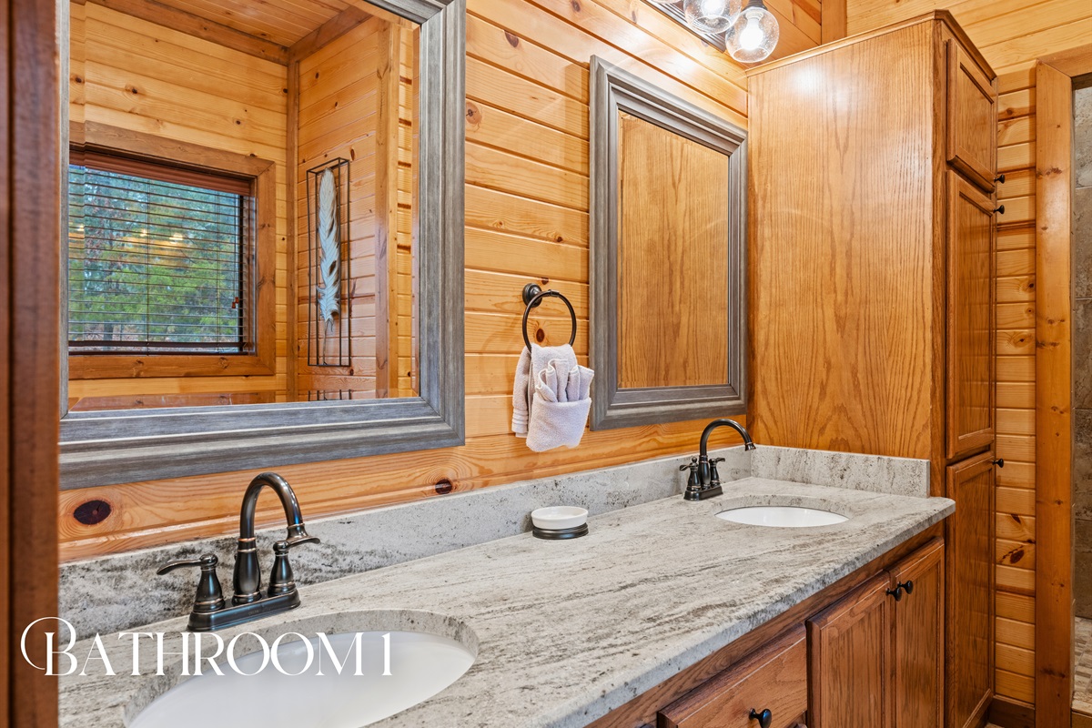 The first bathroom features a spacious vanity with rustic finishes and plenty of room to get ready at a relaxed pace.