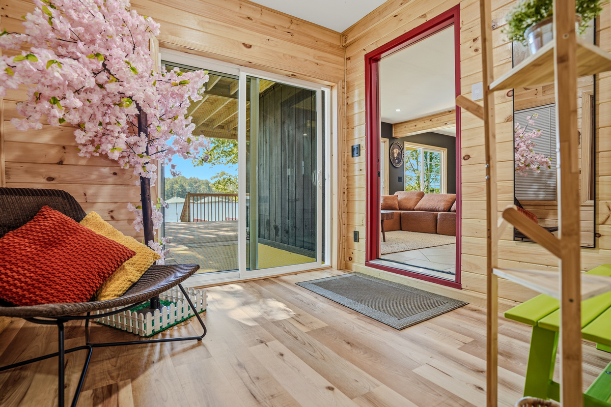  Lower-level entry with sliding doors opening to lake view, cherry blossom arrangement