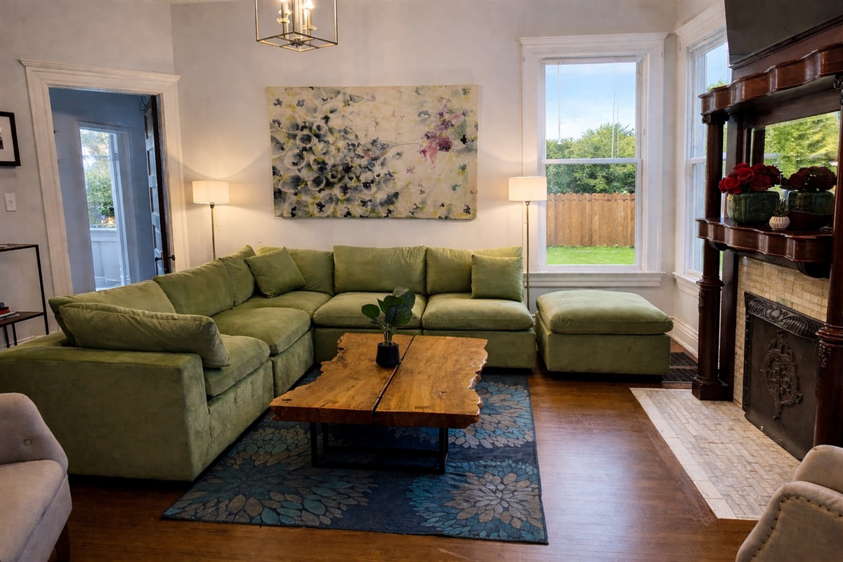 Living Room with Velvet Large Section Sofa and addition side chairs. 55" LED Smart TV.