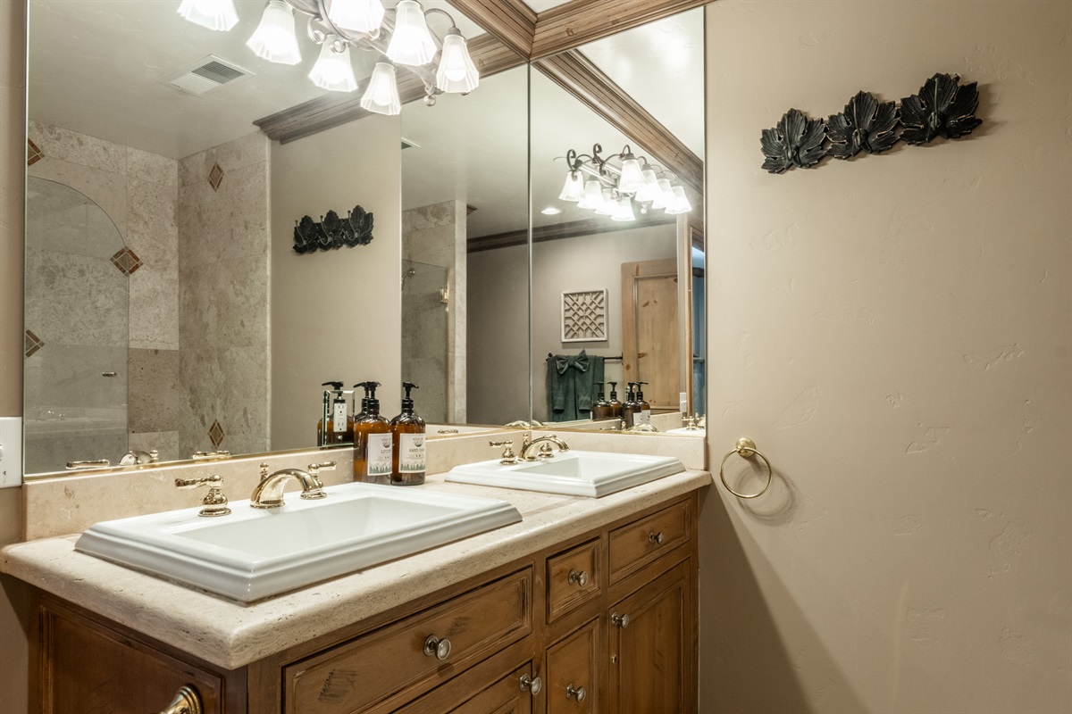 Primary bath with double vanity and tub/shower combo—designed for easy mornings and unhurried evenings.