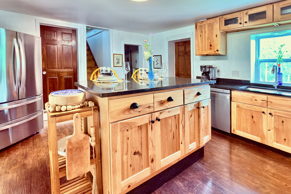 Fully equipped kitchen featuring granite counters, a spacious island, and premium LG appliances. A bright, functional space perfect for preparing meals during your stay.