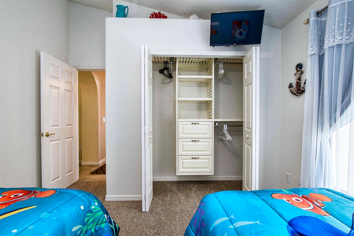 The closet organizer is a great substitute for a dresser.  TV above!