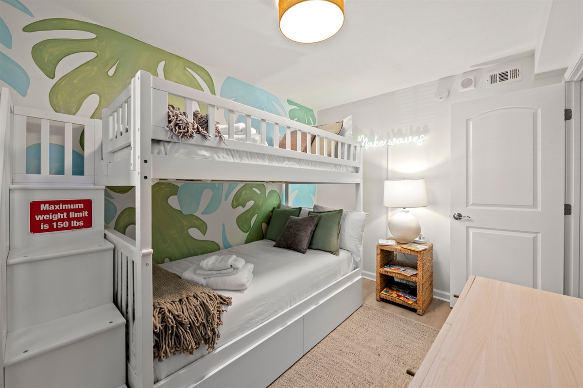 Let the kids settle into their tropical retreat, cozy in bunks beneath playful palm leaves after a day of sun and sand.