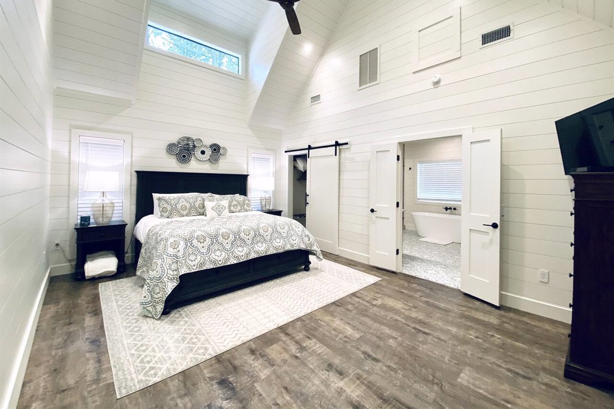 Master Suite: Discover your retreat with stylish decor, vaulted ceilings, and serene views!