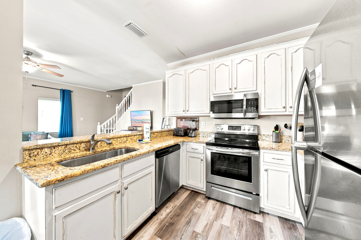 Stainless appliances and generous counter space make meal prep easy, whether it's beach-day snacks or a full dinner.