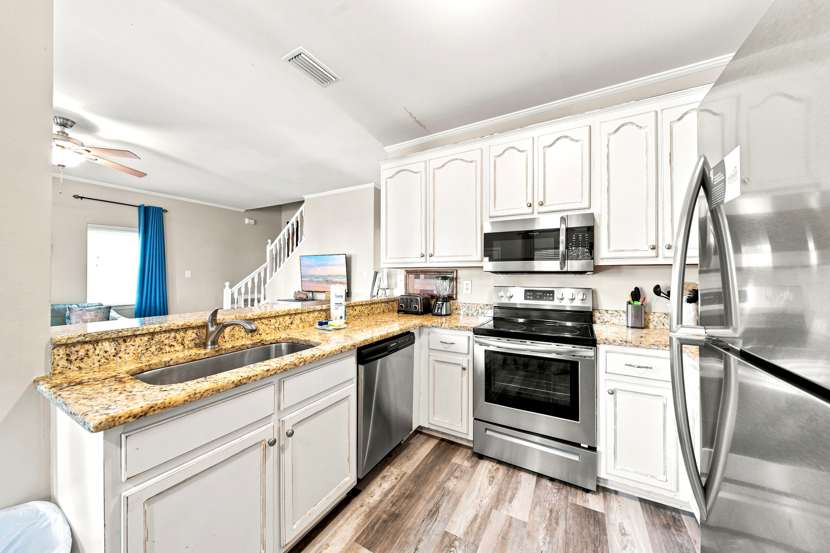 Stainless appliances and generous counter space make meal prep easy, whether it's beach-day snacks or a full dinner.
