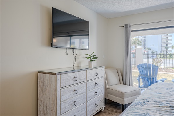 Master bedroom with patio access, ceiling fan and smart TV