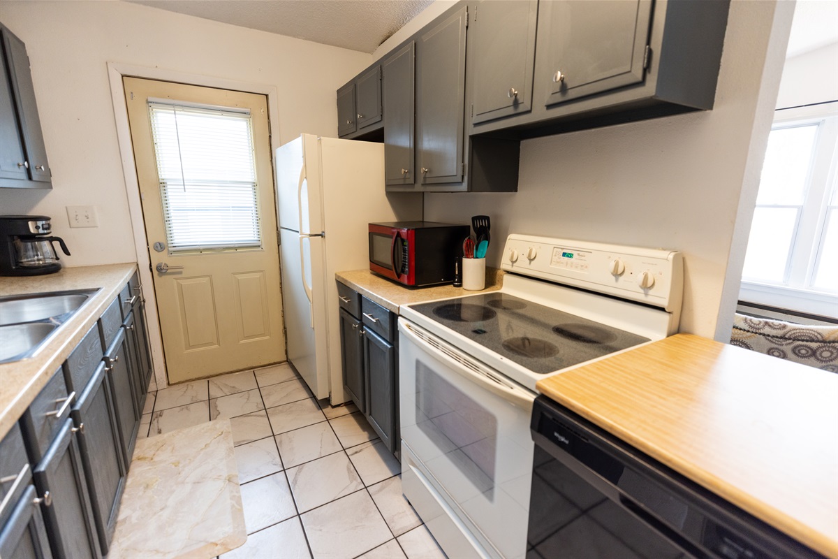 Galley kitchen with portable dishwasher.
