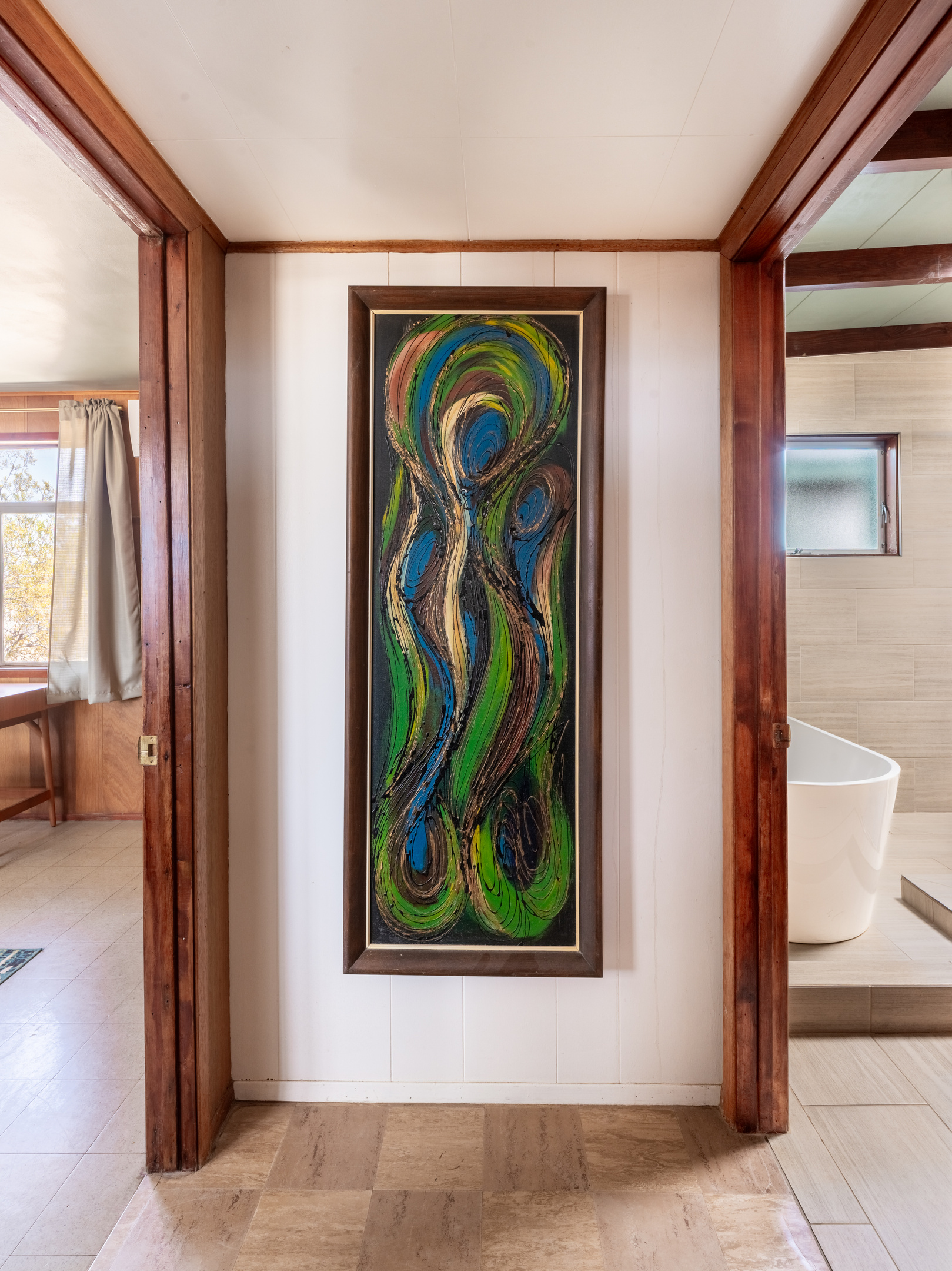 Hallway -- bedroom to the left, bathroom to the right, art in the middle. 