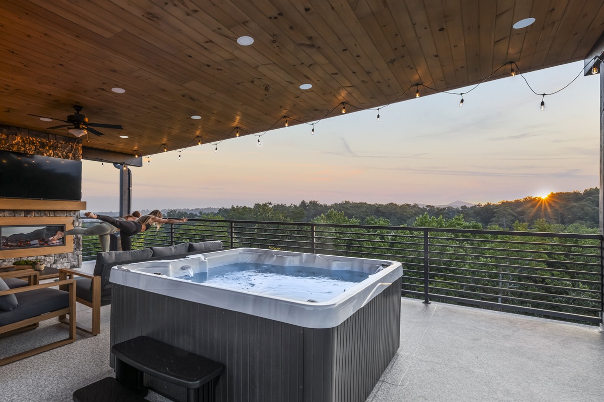 Private rooftop terrace with hot tub, fireplace, and breathtaking sunrise + mountain views.