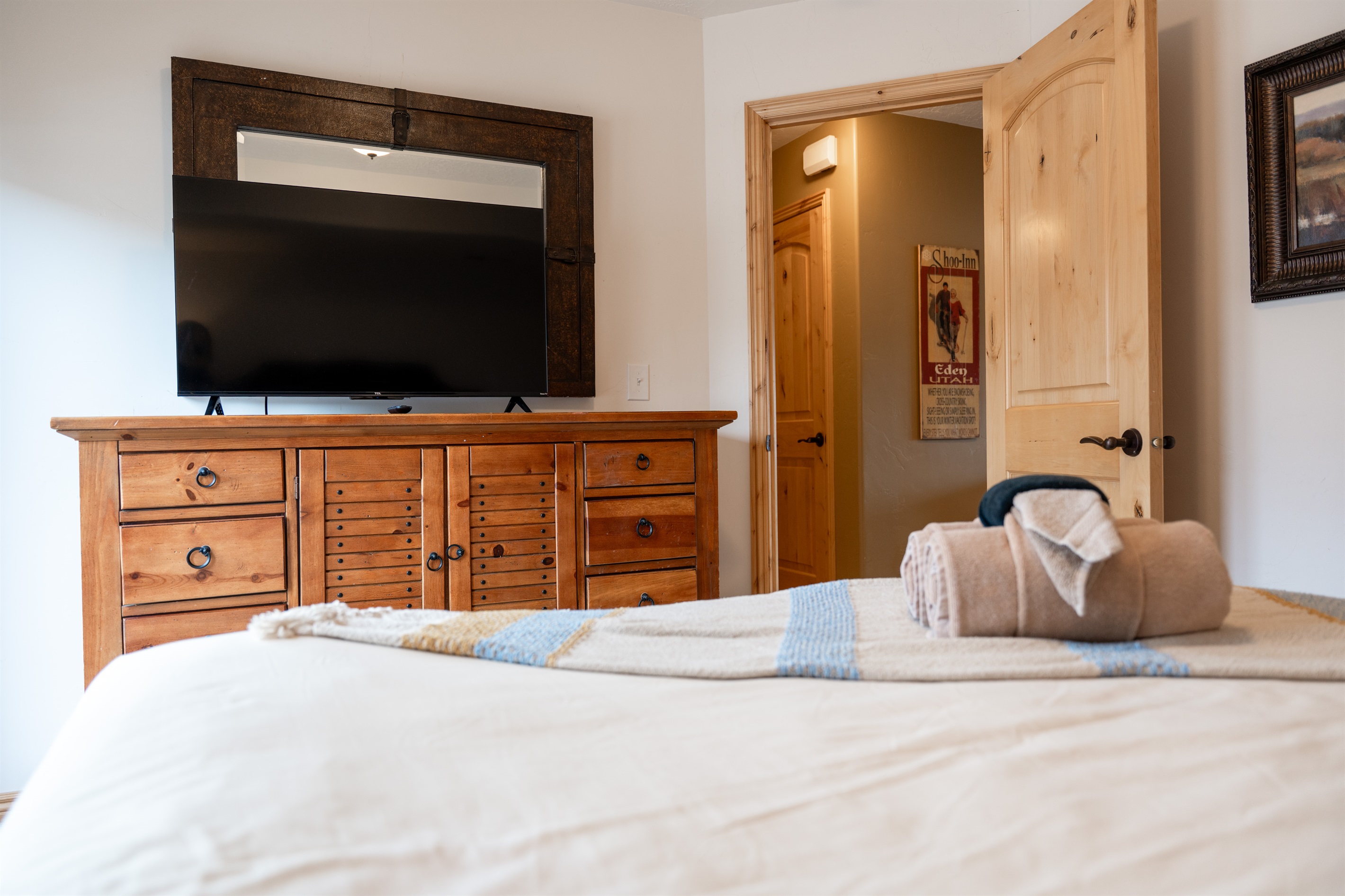 Relaxing bedroom setup with Smart TV and cozy furnishings — ideal for unwinding after a day outdoors.