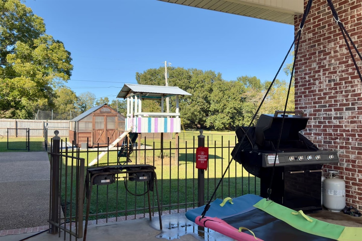 A black grill with propane tank makes the patio perfect for barbecues and gatherings.