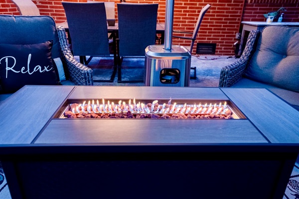 Enjoy a covered outdoor lounge with comfy seating, LED lighting, a fire table, patio heater, and a 65” outdoor TV. Perfect for relaxing, watching games, or spending time together year-round.