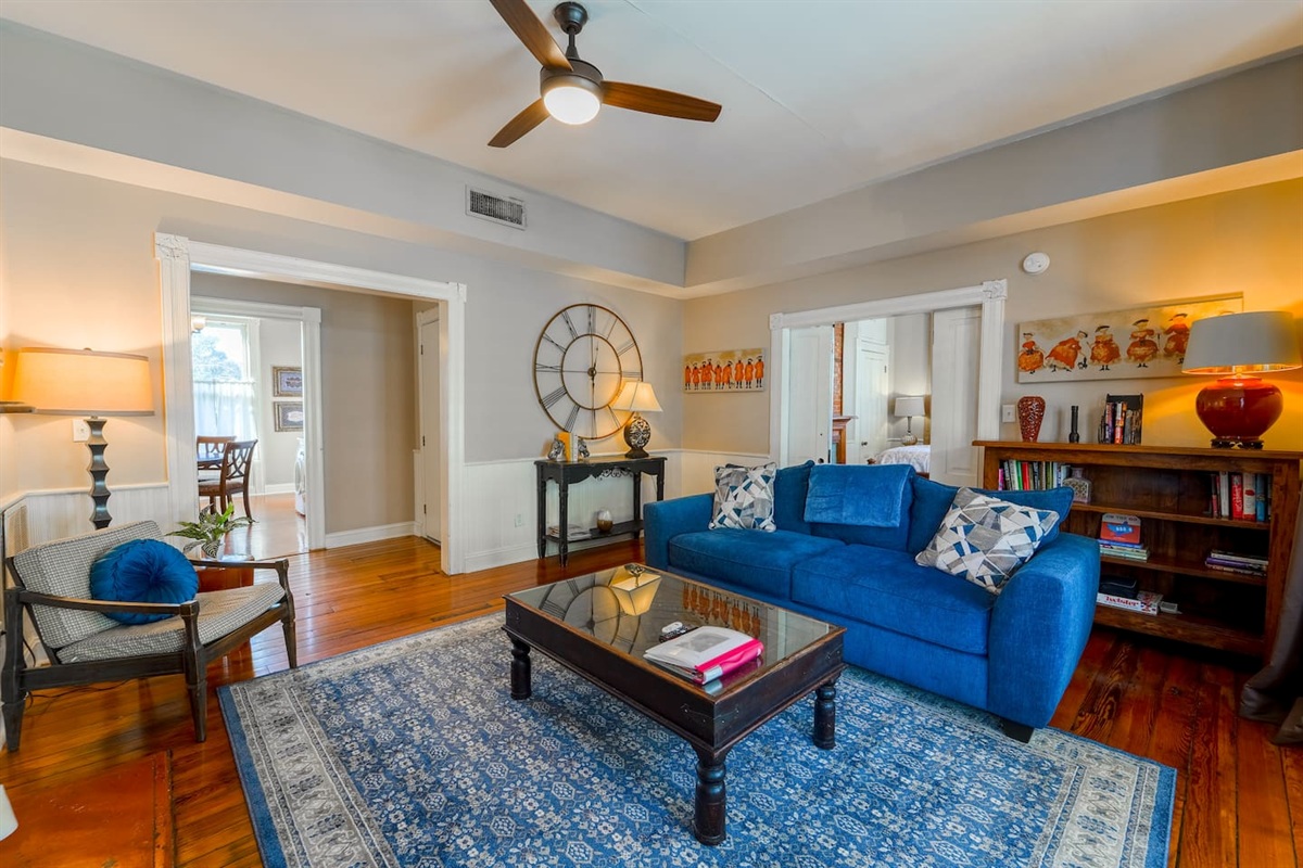 Open living room floor plan with a colorful decor, including games and books. 
