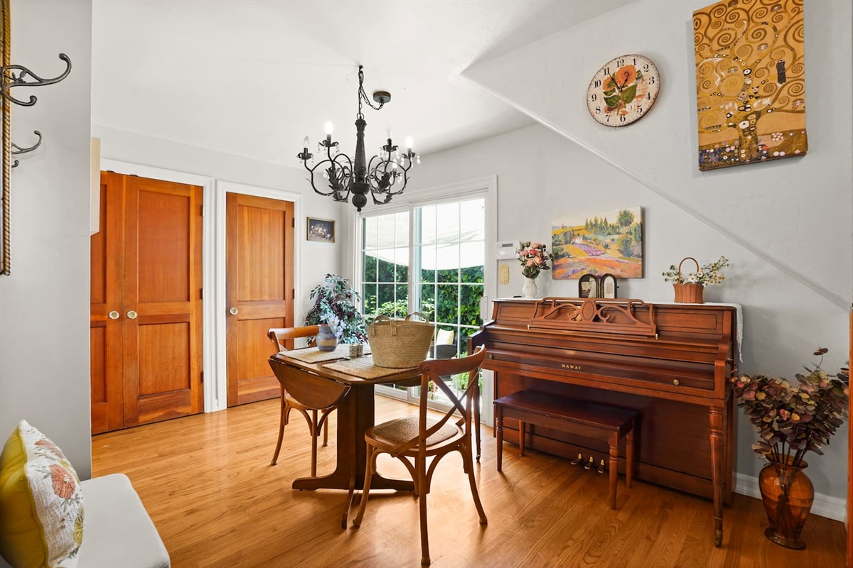 Cozy dining area with a dining table and piano.
