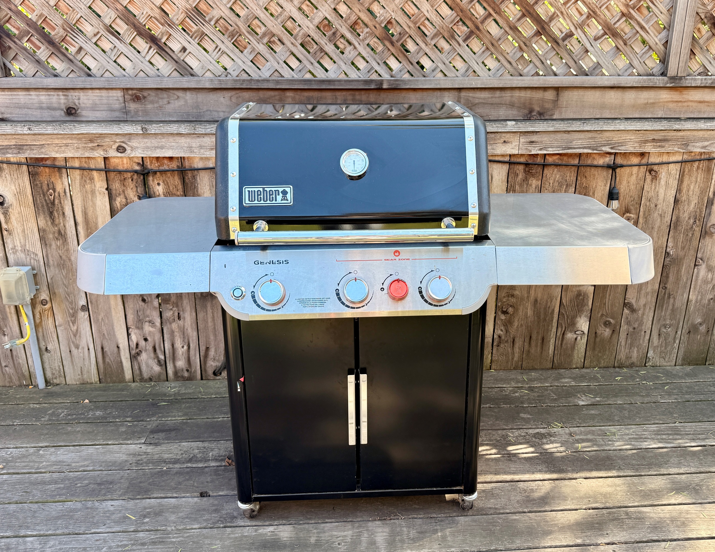 Weber grill with propane included and lots of backups on site. Grilling tools are in the storage area below the grill.