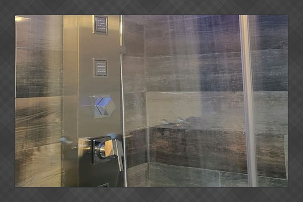 Guest Bath: Waterfall shower with body jets, blue light therapy, and hand held shower wand