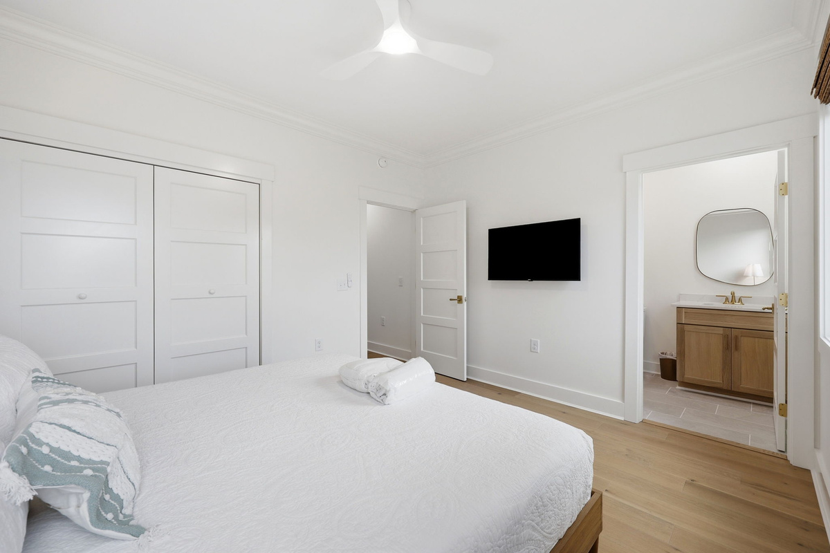 Second-floor king bedroom with ocean-inspired accents and private ensuite access