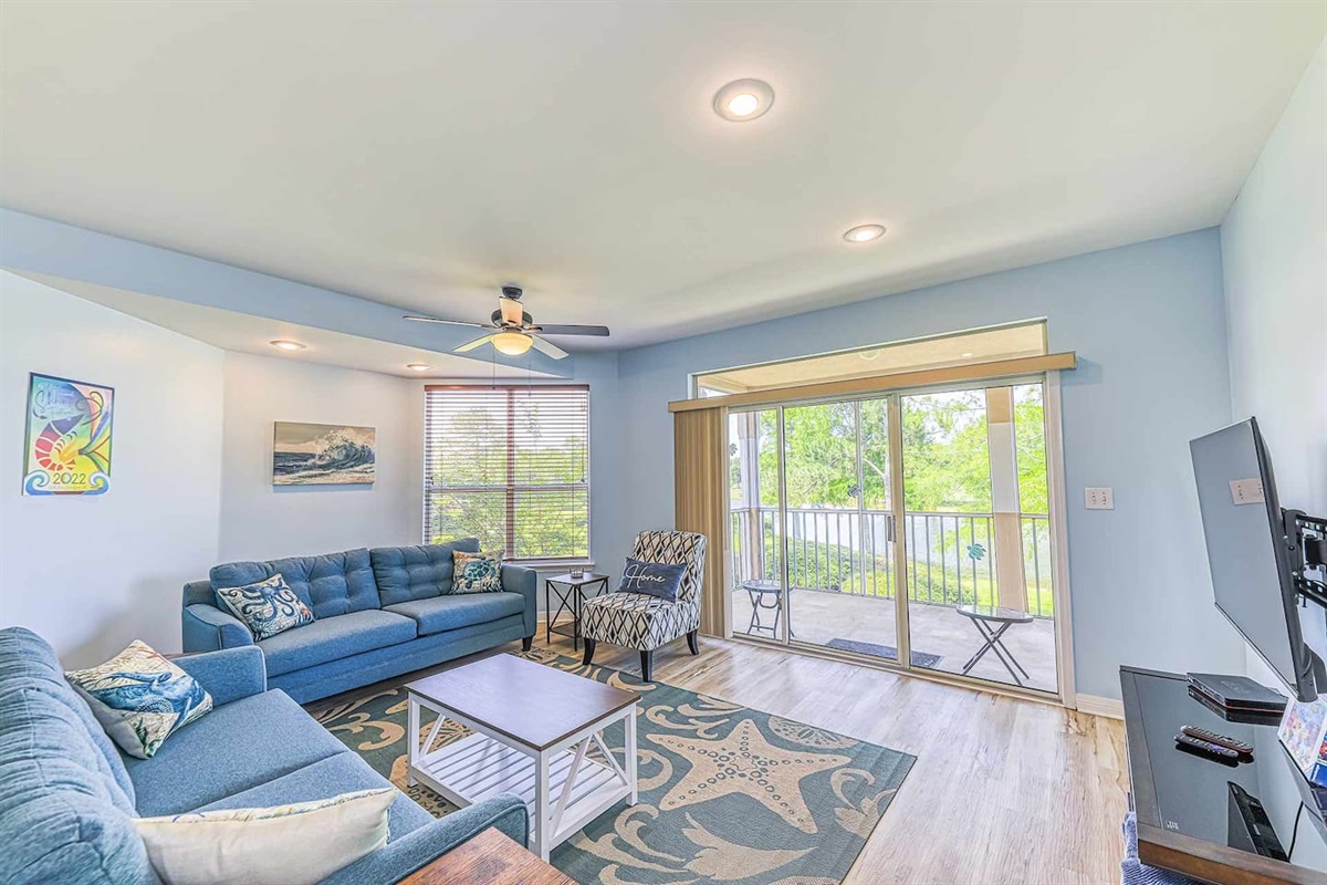 Living Room: Bright and airy space with vibrant decor, perfect for relaxing after beach adventures!