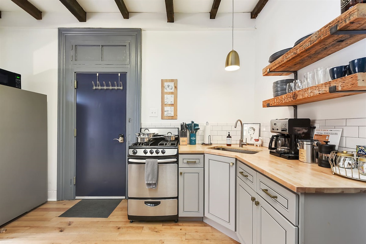 Fully equipped kitchen featuring modern design and sleek stainless steel appliances — ready for all your cooking needs.