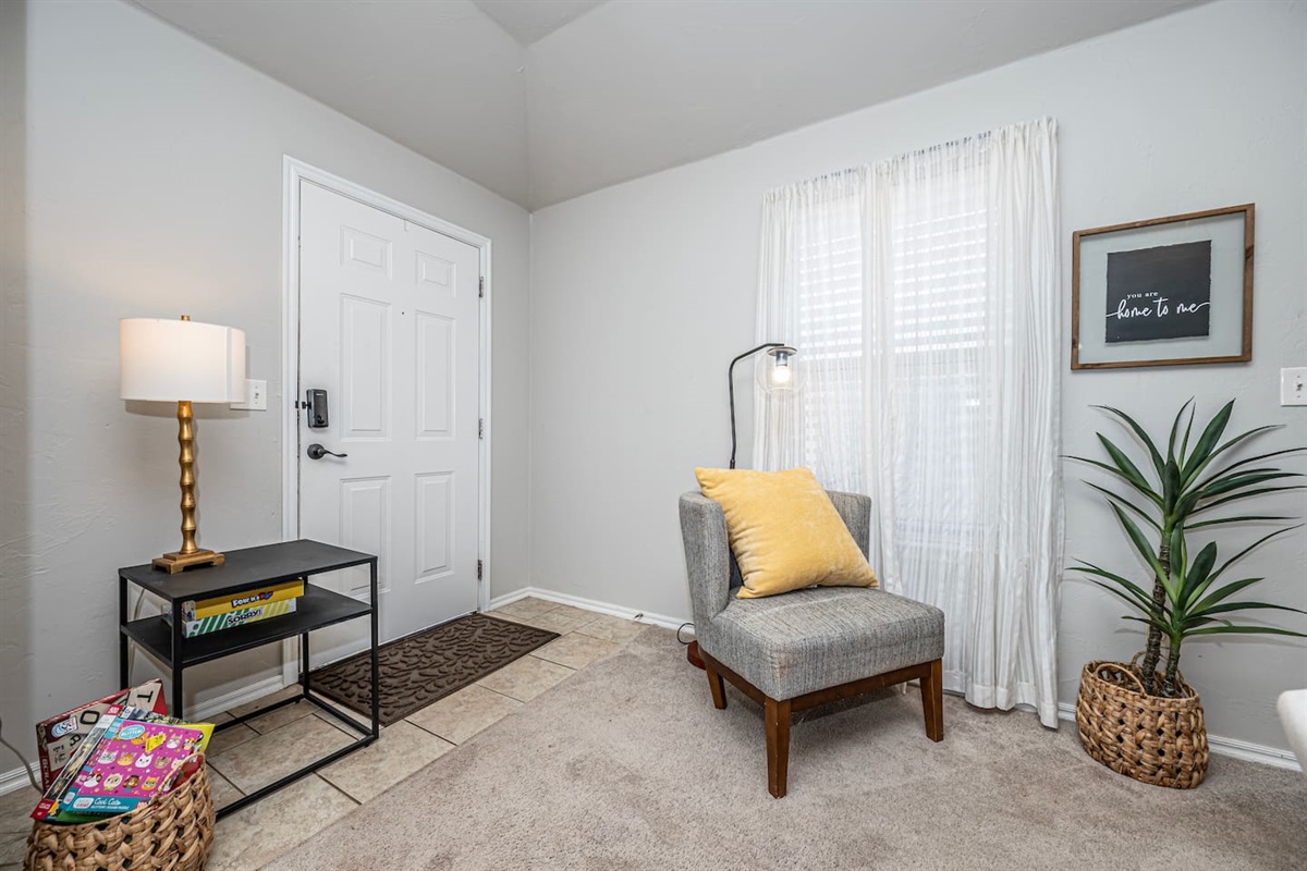 Spacious living area featuring comfortable seating, smart TV, and a warm fireplace.