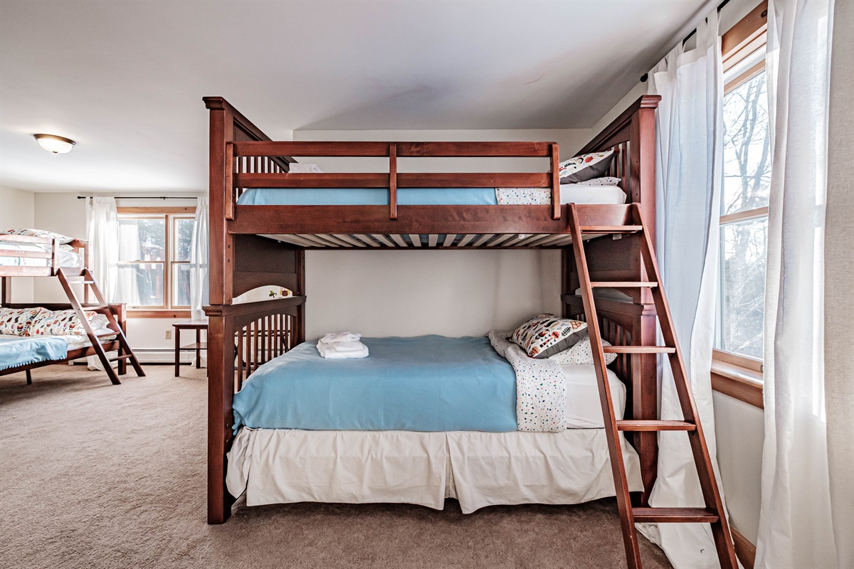 Bunk room with multiple beds for flexible accommodations.