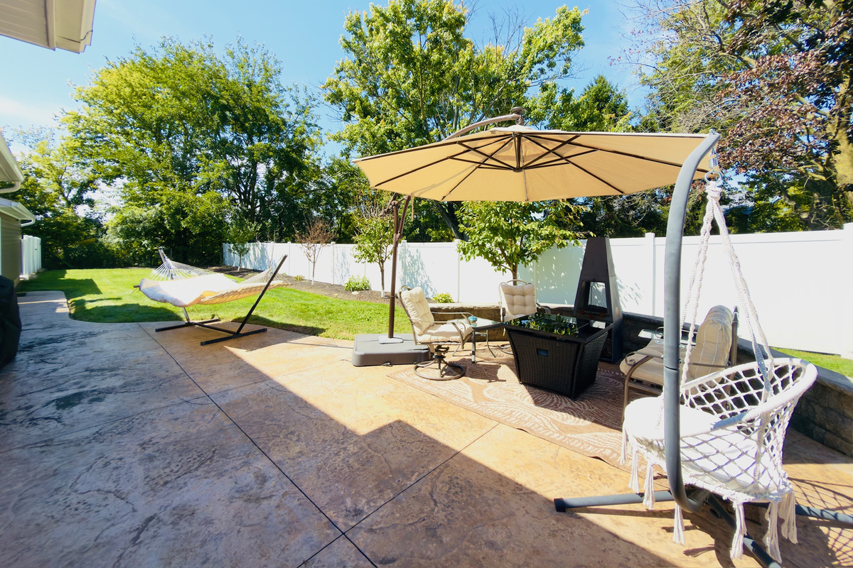 Spacious patio with multiple seating areas for meals and evenings outside.