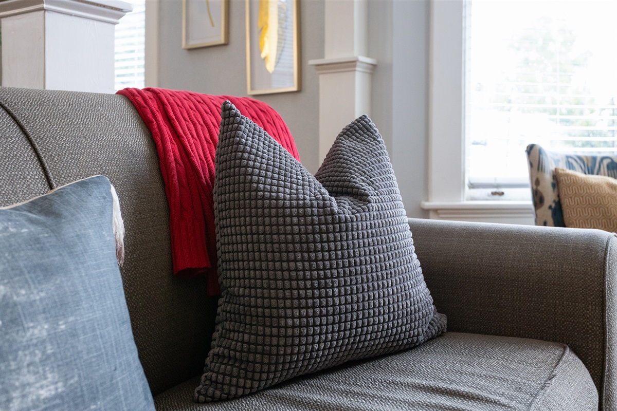 Soft textures and layered pillows bring comfort to every corner.