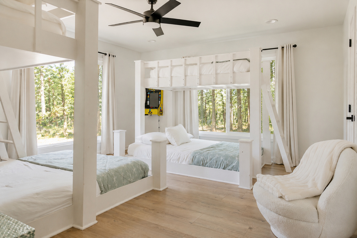 Bunk room: two queen lower beds and two single/twin upper beds—four beds total. The cabin also has three private king bedrooms.
