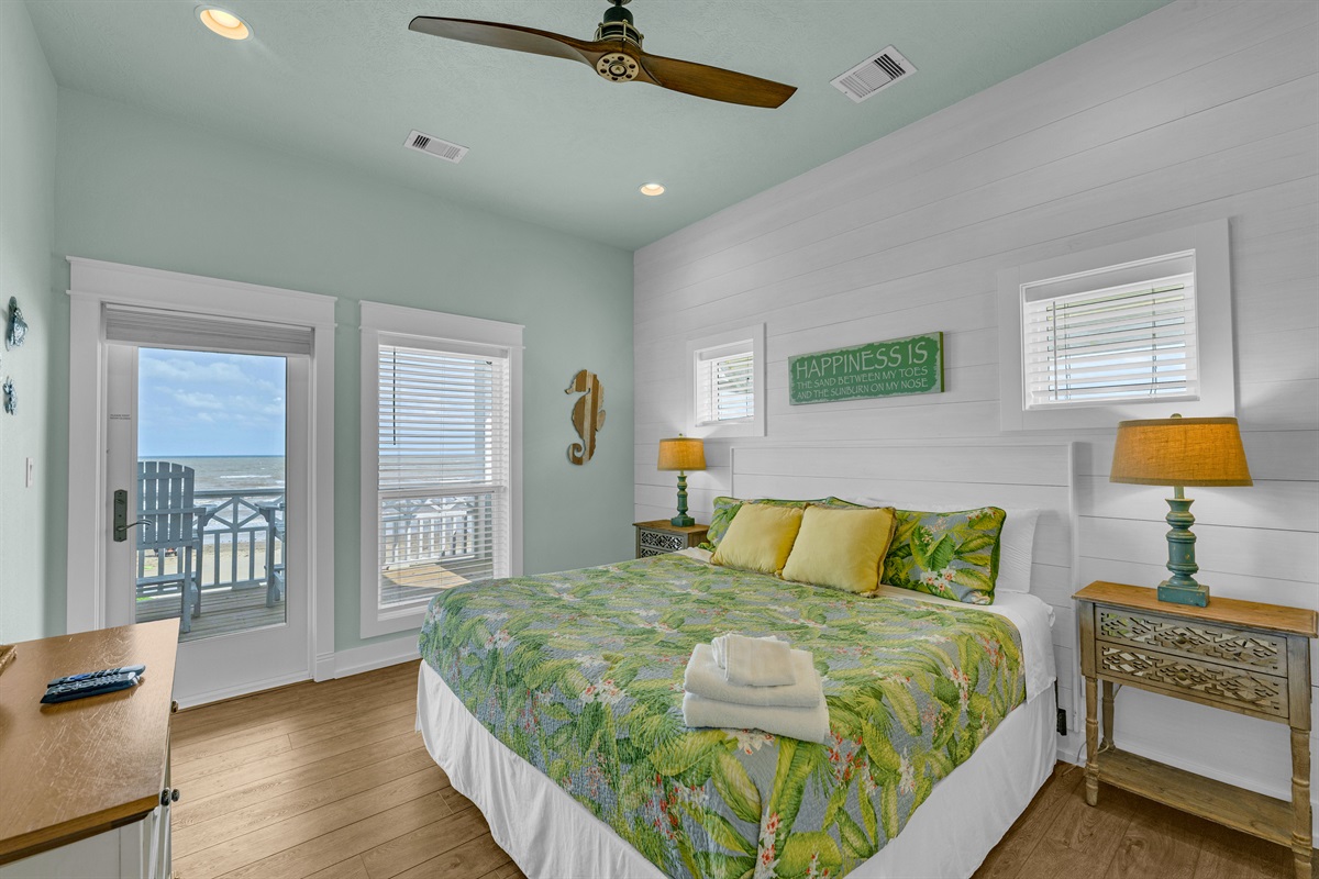 Sea It All: Primary bedroom on the second floor with private access to the upper viewing deck. 