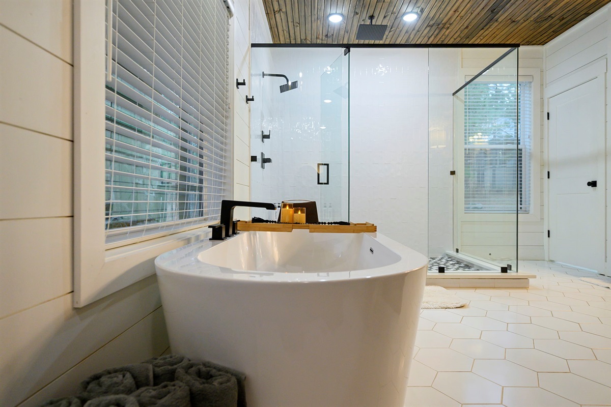 Spa-inspired bathroom with soaking tub and walk-in glass shower. 🛁