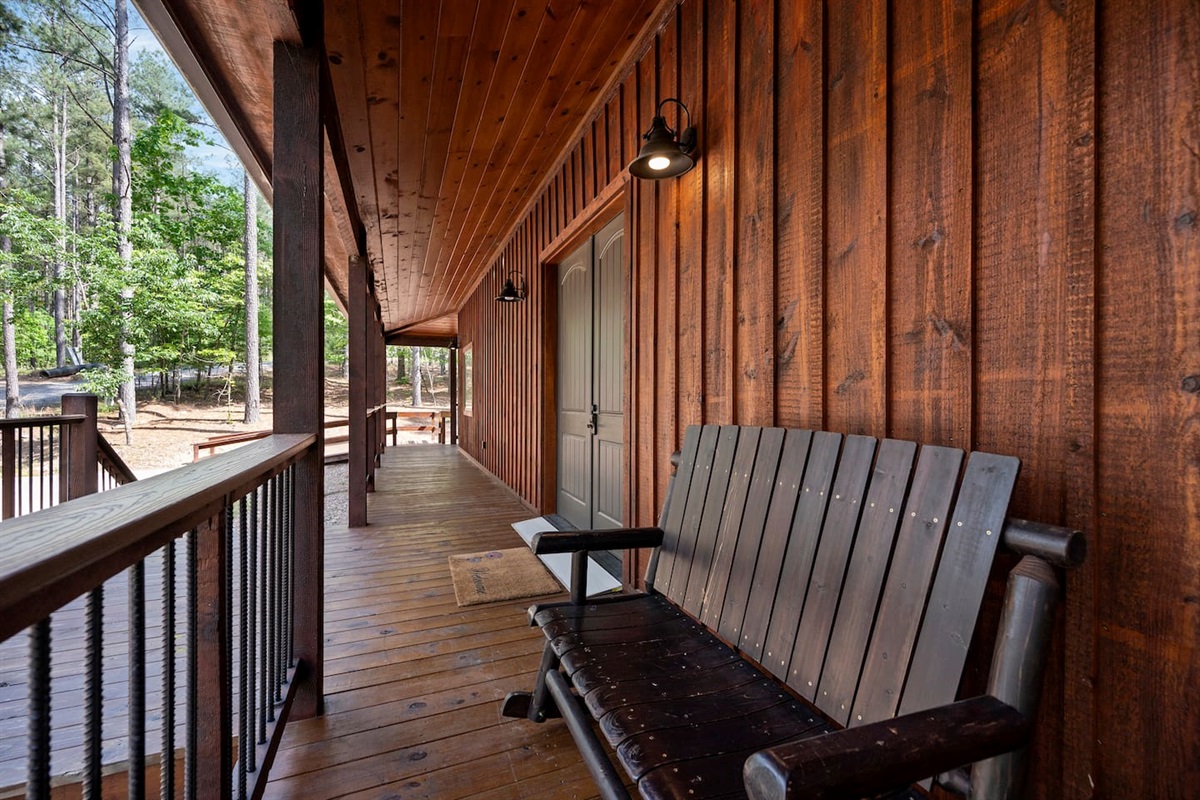 The wide porch encircles the entire cabin, with several sitting areas for resting and relaxing