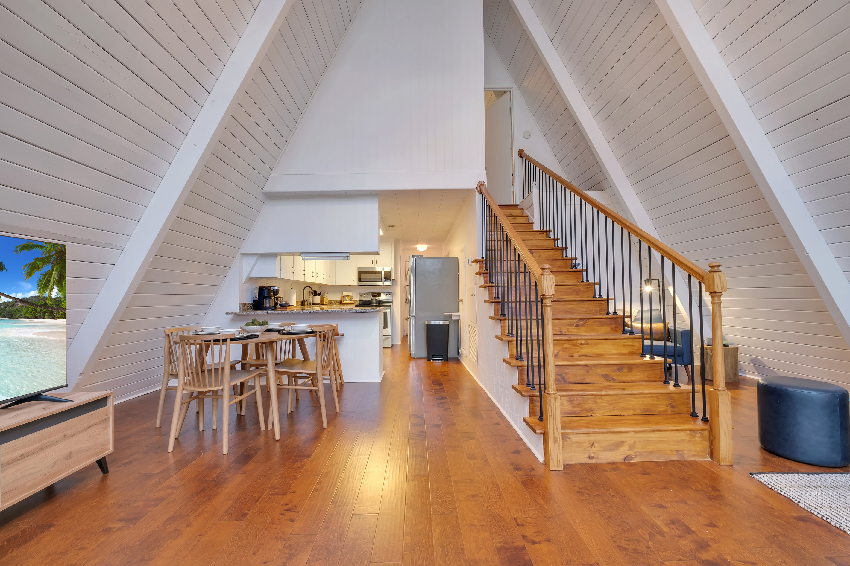 Open living, dining and kitchen, stairs to the upstairs bedroom