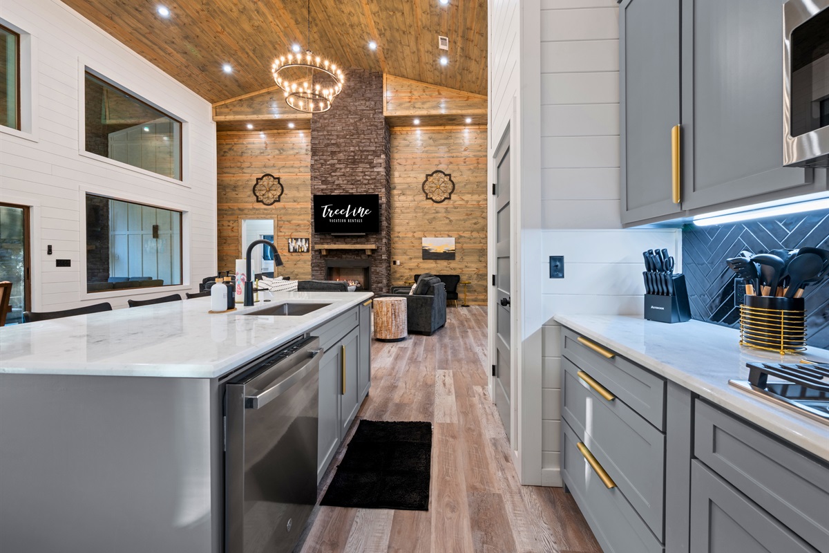 The long kitchen layout provides plenty of counter space and storage, giving everyone room to help with meals or snacks.