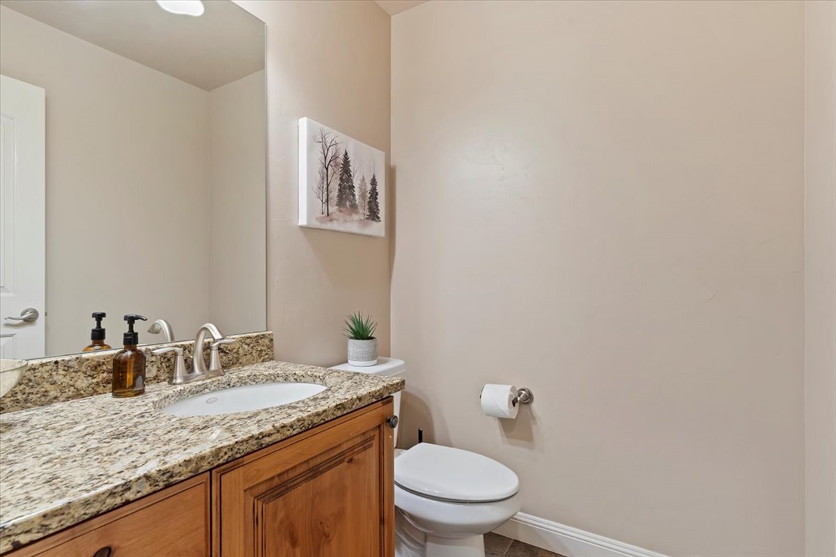 A stylish main-level half bath with modern finishes, offering convenience for guests and everyday living.