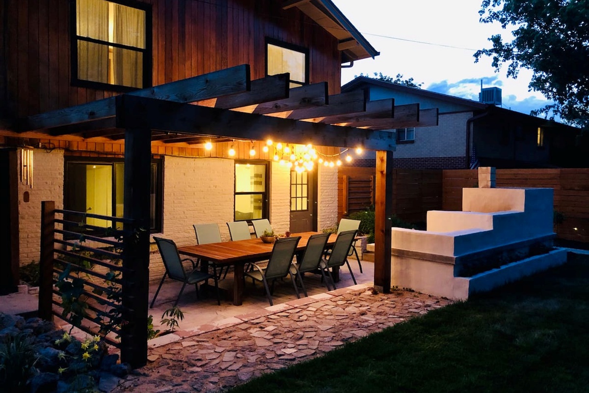 Outdoor patio with custom-built kitchen and seating for eight
