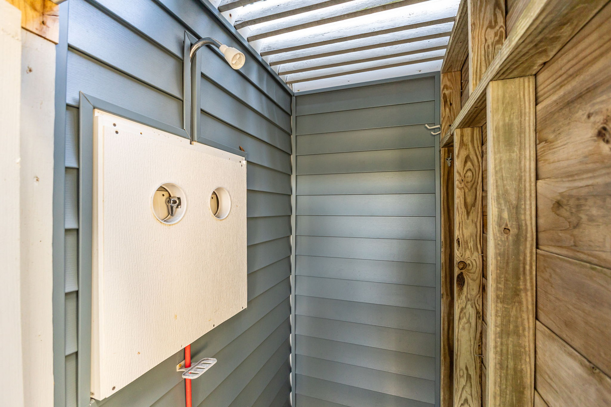 Outdoor shower area perfect for rinsing off after a day at the beach